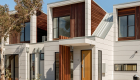 exterior photography of West Footscray townhouse new development, architectural design, iron bark wood features, white facade, roger thompson photography, blue sky,