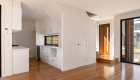 interior photography of West Footscray townhouse new development, architectural design, solid wood floor, white walls, roger thompson photography,, living area, kitchen, front door