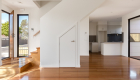 interior photography of West Footscray townhouse new development, architectural design, solid wood floor, white walls, roger thompson photography,, living area, kitchen, front door