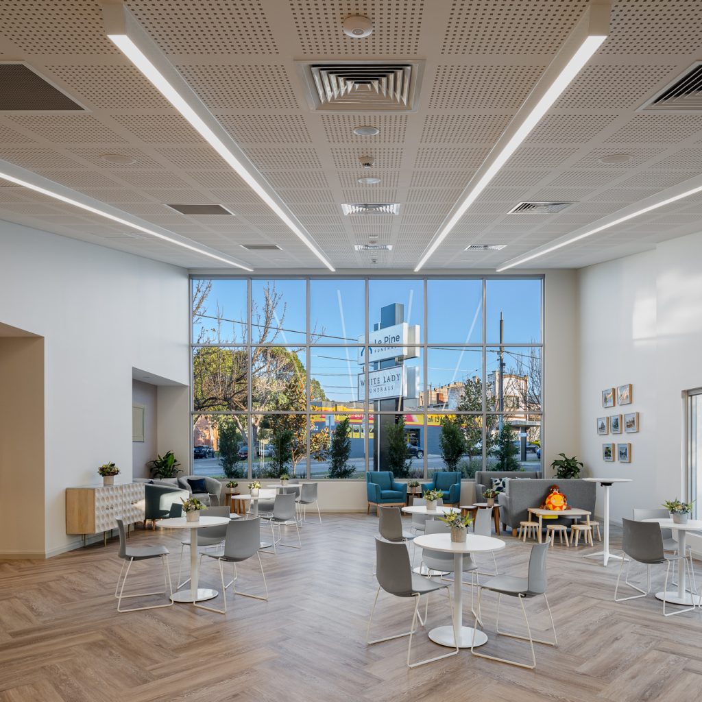 Le Pine and white lady funeral home communal gathering area internal photo showing seating and large bright front windows by Roger Thompson Photography Melbourne