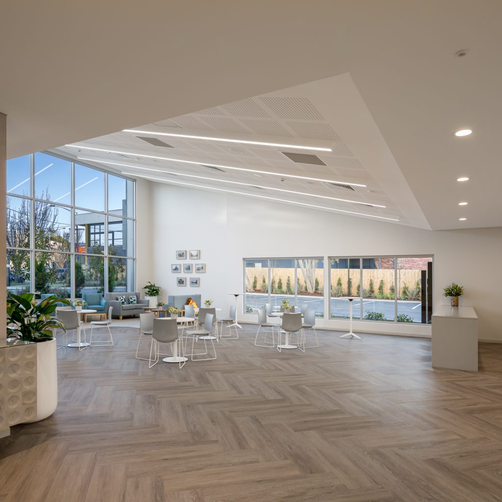 Le Pine and white lady funeral home communal gathering area internal photo showing seating and serving counter area with large bright front windows photo by Roger Thompson Photography Melbourne