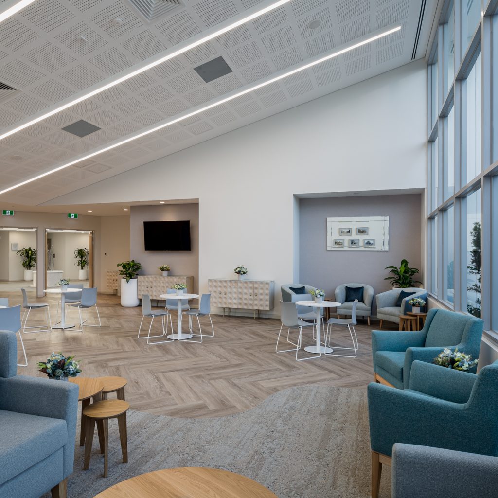 Le Pine and white lady funeral home communal gathering area internal photo showing seating area with large bright front windows photo by Roger Thompson Photography Melbourne