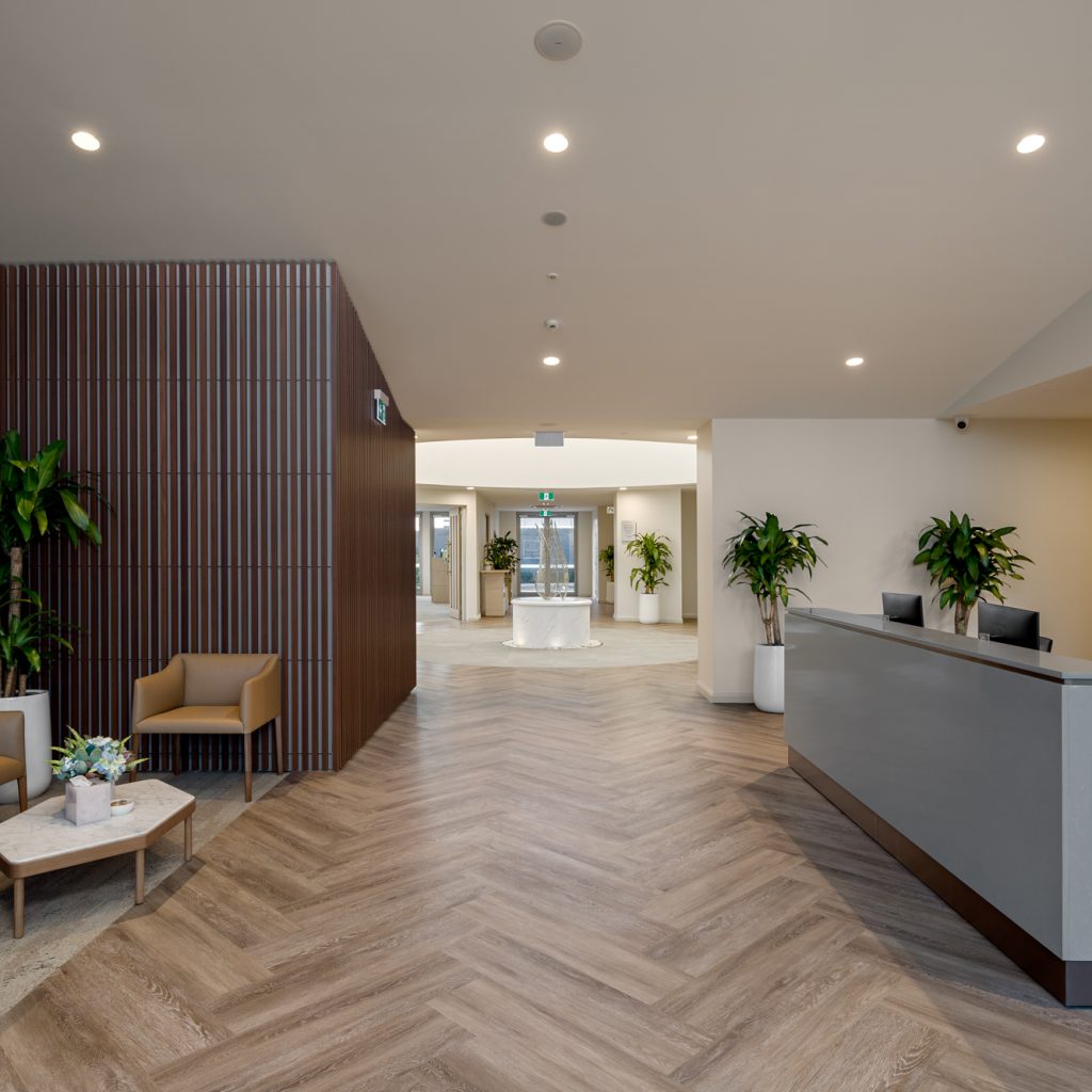 Le Pine and white lady funeral home entry foyer reception area photo looking though to circular grand hallway with water feature sculpture by Roger Thompson Photography Melbourne