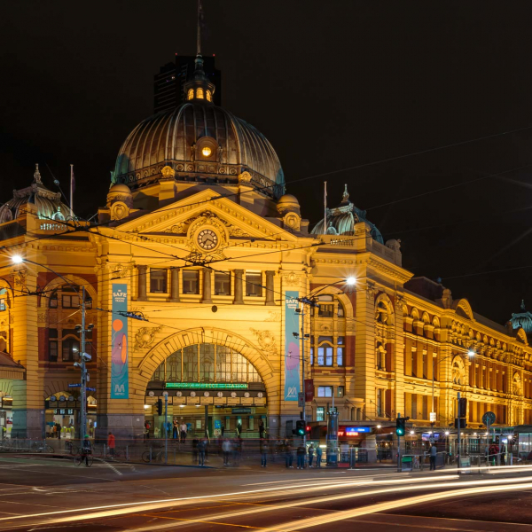 flinders street station illuminated building in cityscape melbourne long exposure photographed at night with car headlights blurred passing by