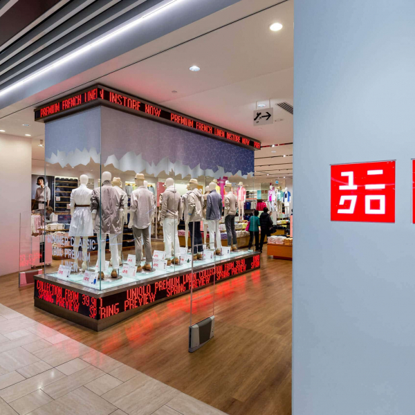 uni-qlo clothing store shop front photo looking in to the store opening and mannequin clothing display with LED signage around display